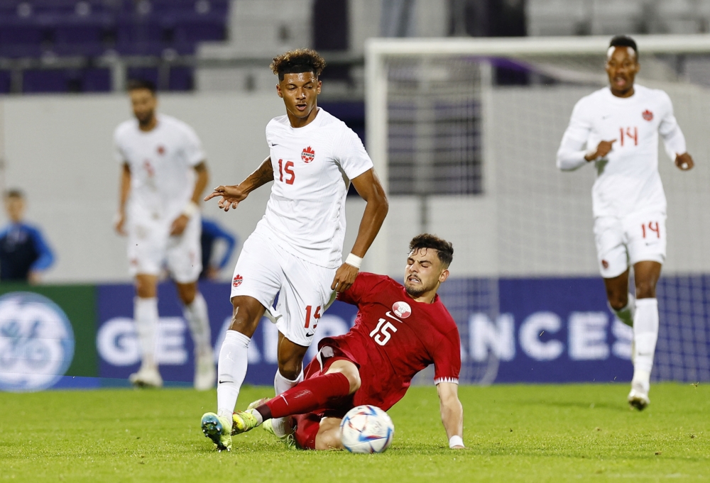 Canada's Charles-Andreas Brym in action with Qatar's Bassam Hisham Ali Al-Rawi during a friendly match at Estadio Franz Horr, Vienna, Austria, on September 23, 2022. (REUTERS/Lisa Leutner)