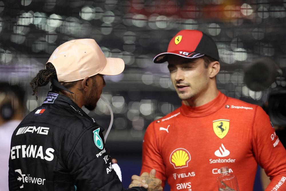 Ferrari's Charles Leclerc celebrates after qualifying in pole position with Mercedes' Lewis Hamilton at the Singapore Grand Prix in Marina Bay Street Circuit, Singapore, on October 1, 2022. REUTERS/Edgar Su