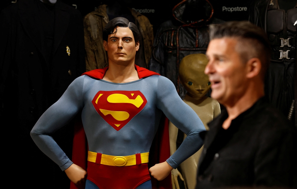 Propstore CEO Stephen Lane stands with Superman's (Christopher Reeve) complete costume from 