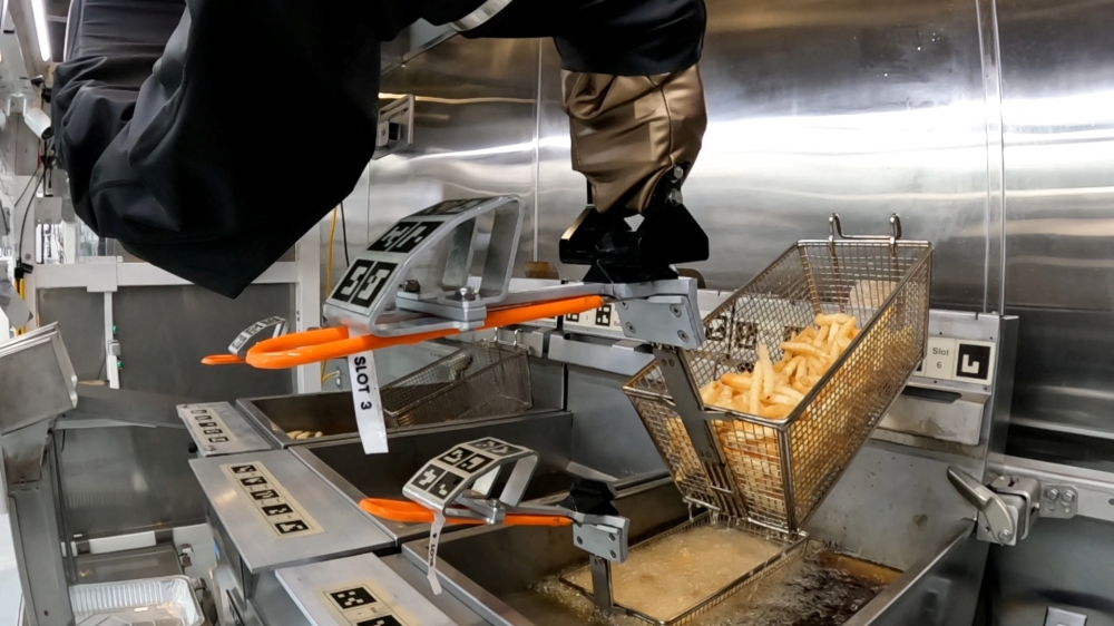 The Flippy 2 robot takes fries out of a vat of oil at a lab of manufacturer Miso Robotics Inc in Pasadena, California, U.S. September 27, 2022, in this screen grab from a REUTERS video. Sandra Stojanovic/REUTERS TV via REUTERS