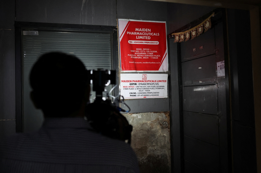 A cameraman takes visuals outside the office of Maiden Pharmaceuticals Ltd. company, in New Delhi, India, October 6, 2022. REUTERS/Anushree Fadnavis