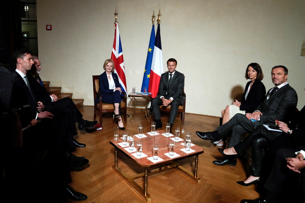 British Prime Minister Liz Truss, center left, poses with France's President Emmanuel Macron during a meeting on the sidelines of the European Political Community meeting at Prague Castle in Prague, Czech Republic on October 6, 2022.  Alastair Grant/Pool via REUTERS