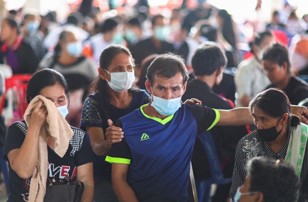 Family members of victims react as they gather outside the day care centre which was the scene of a mass shooting, in the town of Uthai Sawan, around 500 km northeast of Bangkok, in the province of Nong Bua Lam Phu, Thailand October 7, 2022. REUTERS/Athit Perawongmetha