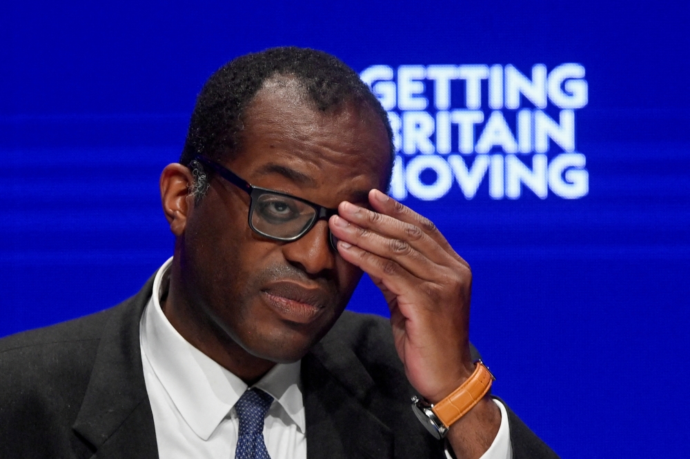 British Chancellor of the Exchequer Kwasi Kwarteng adjusts his glasses during Britain's Conservative Party's annual conference in Birmingham, Britain, October 3, 2022. REUTERS/Toby Melville/File Photo