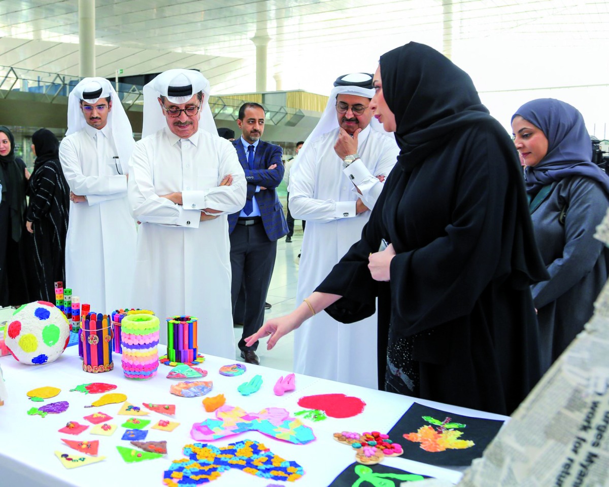 Minister of State and President of Qatar National Library H E Dr. Hamad bin Abdulaziz Al Kawari (second left) and H E Dr. Mohammed bin Saleh Al Sada (third right) with officials during a tour of the exhibition. 