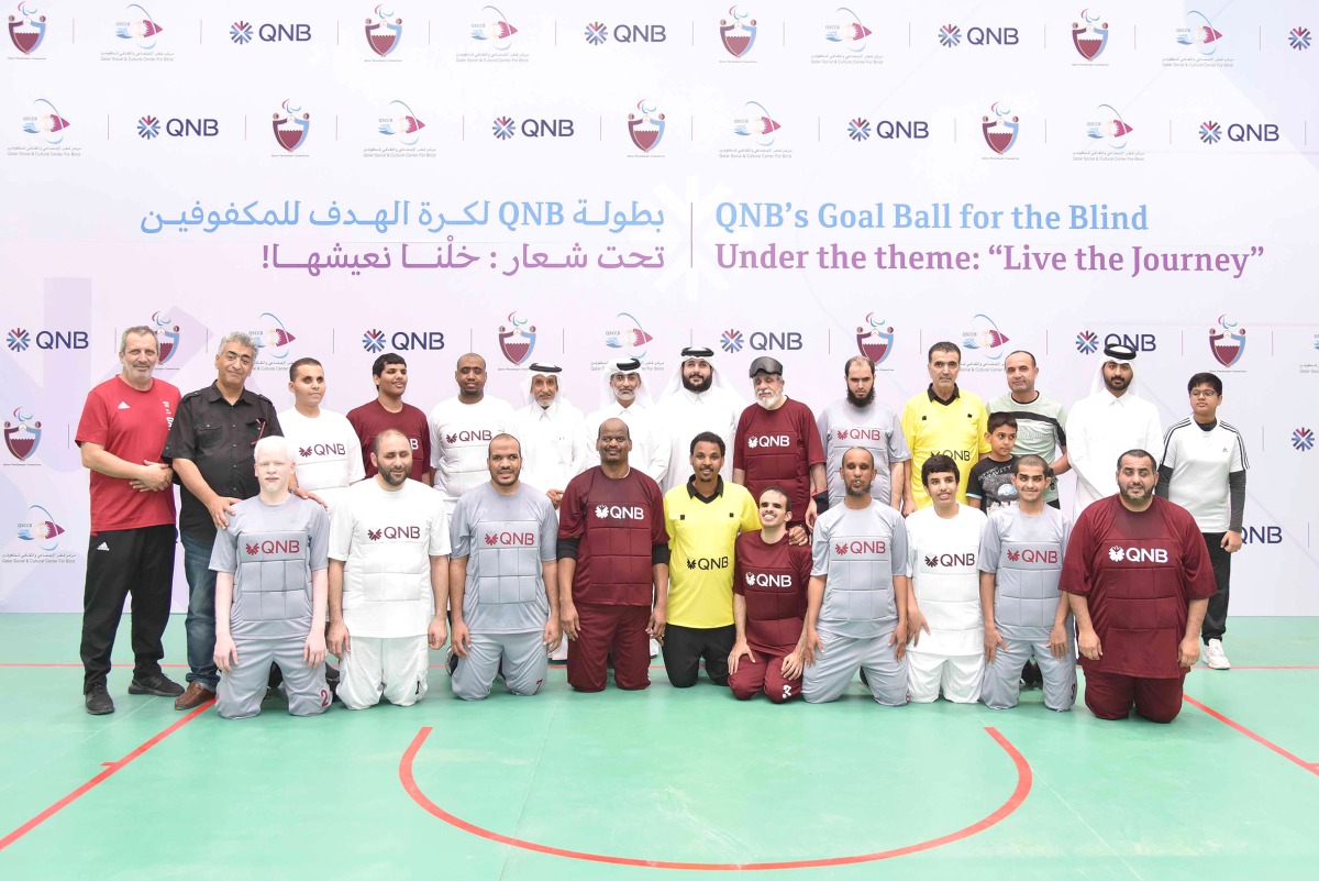 Officials and participants from QNB and QSCCB, during the “Goalball for the Blind” tournament, recently. 