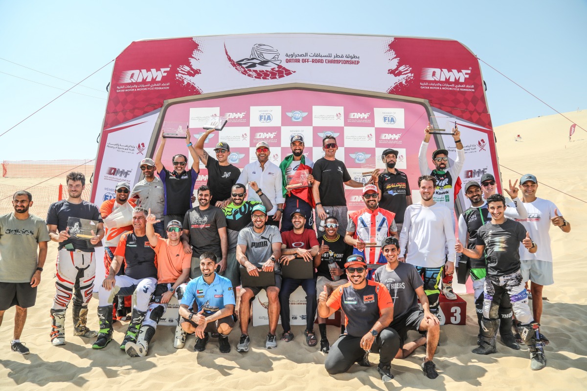 The podium winners of bike events pose for a photograph with officials of Qatar Motor and Motorcycle Federation after the conclusion of the fifth round of 2022 Qatar Off Road Championship.