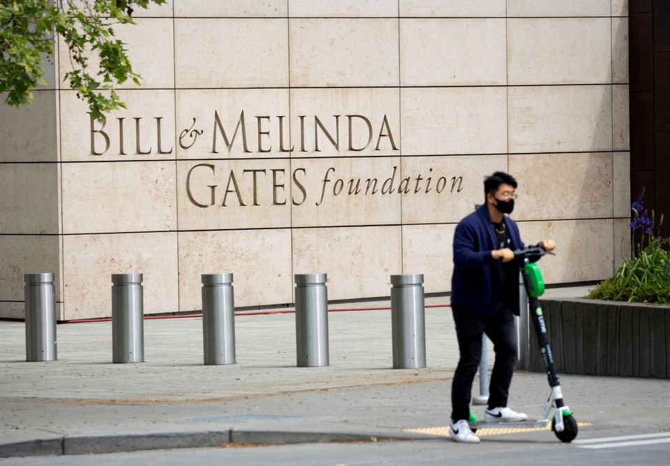 A person passes by on a scooter in front of the Bill & Melinda Gates Foundation in Seattle, Washington, US, on May 5, 2021.  File Photo / Reuters