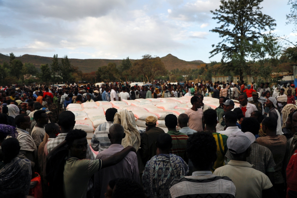People stand in line to receive food donations, at the Tsehaye primary school, which was turned into a temporary shelter for people displaced by conflict, in the town of Shire, Tigray region, Ethiopia, on March 15, 2021.  File Photo / Reuters