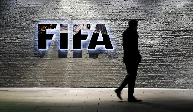 A journalist walks in front of FIFA's headquarters in Zurich, Switzerland December 2, 2015. File Photo / Reuters
