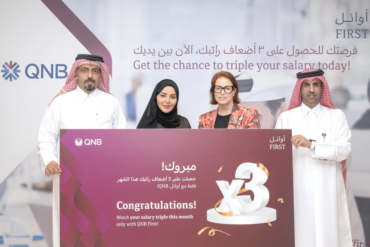 QNB officials award the last winner of the Triple your Salary campaign, in Doha, recently. 