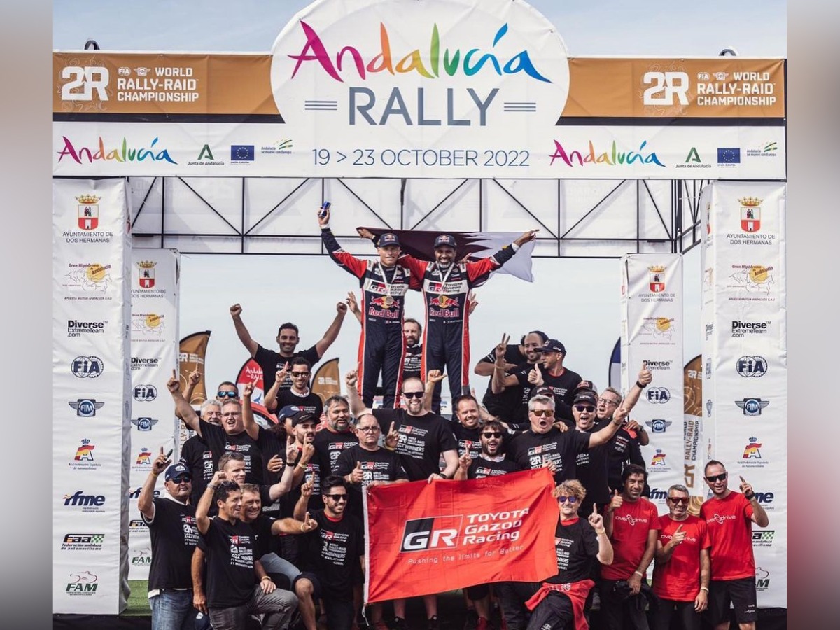 Qatar's Nasser Saleh Al Attiyah and his French co-driver Mathieu Baumel celebrate with their crew after winning the FIA World Rally-Raid Championship drivers' title.