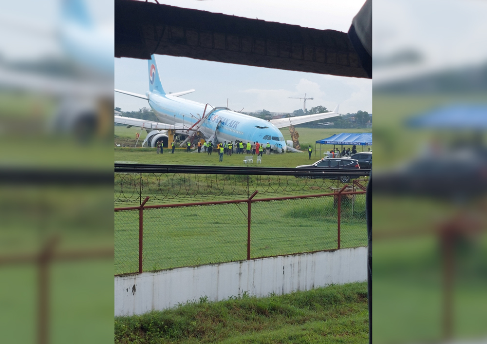 Response crews gather around a Korean Air Airbus A330 widebody flying from Seoul to Cebu, which tried to land twice in poor weather before it overran the runway on the third attempt on Sunday, in Lapu-Lapu City, Cebu, Philippines October 24, 2022 in this picture obtained from social media. Randyl Dungog/via REUTERS