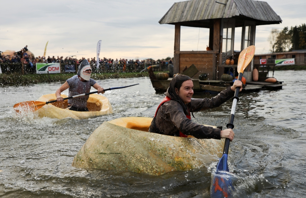 Contestants compete during the Pumpkin Regatta, an annual pumpkin boat relay race, in the Belgian town of Kasterlee, Belgium October 23, 2022. REUTERS/Bart Biesemans