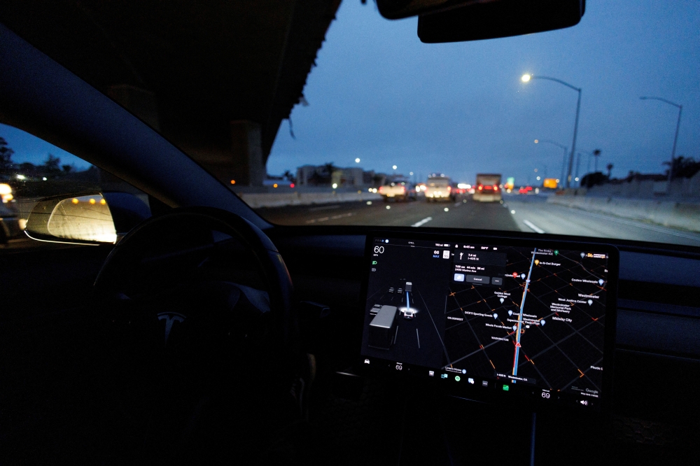 A Tesla Model 3 vehicle drives on autopilot along the 405 highway in Westminster, California, US, March 16, 2022. (REUTERS/Mike Blake)