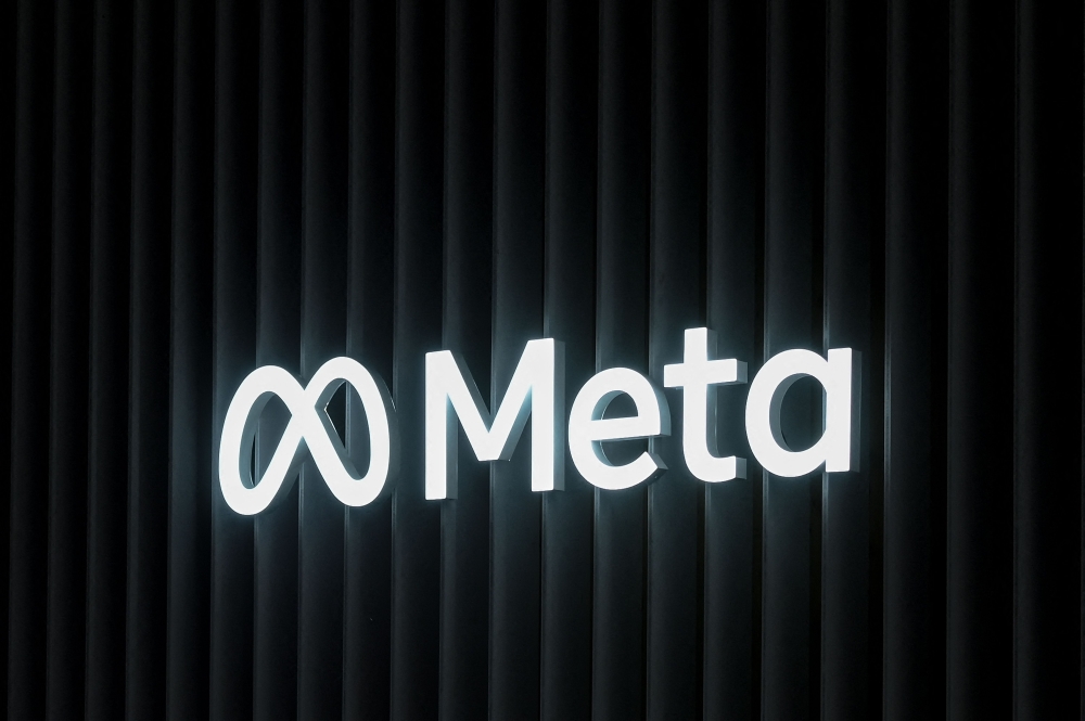 In this file photo taken on May 22, 2022 this photograph the logo of US multinational technology conglomerate Meta is displayed on a booth ahead of the World Economic Forum (WEF) annual meeting in Davos. Photo by FABRICE COFFRINI / AFP)