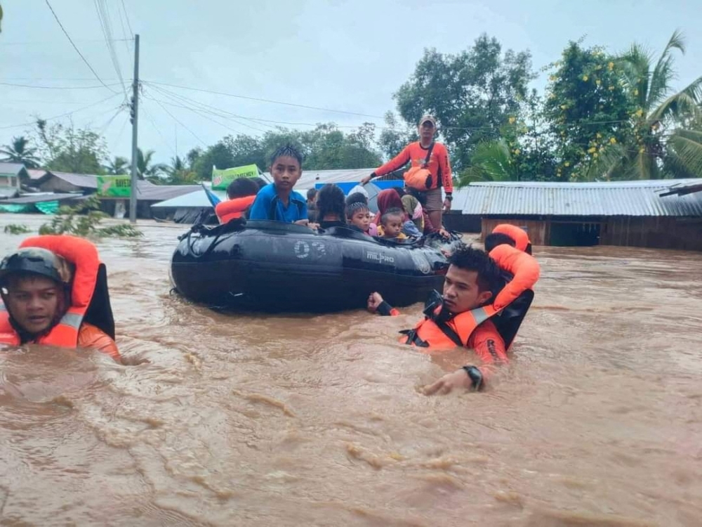 Philippine Coast Guard (PCG) rescuers evacuate residents from their flooded homes due to a tropical storm, locally named Paeng, in Maguindanao province, Philippines, October 28, 2022. Philippine Coast Guard/Handout via REUTERS