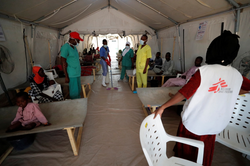 Health workers and patients are seen inside a cholera treatment tent for severe cases at the Medecins Sans Frontieres (MSF - Doctors without Borders) Cholera Treatment Center, in Maiduguri, Borno State, Nigeria October 18, 2022. REUTERS/Christophe Van Der Perre