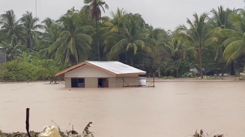 Flood waters surround a building following a heavy storm in Datu Odin Sinsuat, Maguindanao, Philippines October 28, 2022 in this still image obtained from a social media video. Alizain A. Tahir/via REUTERS
