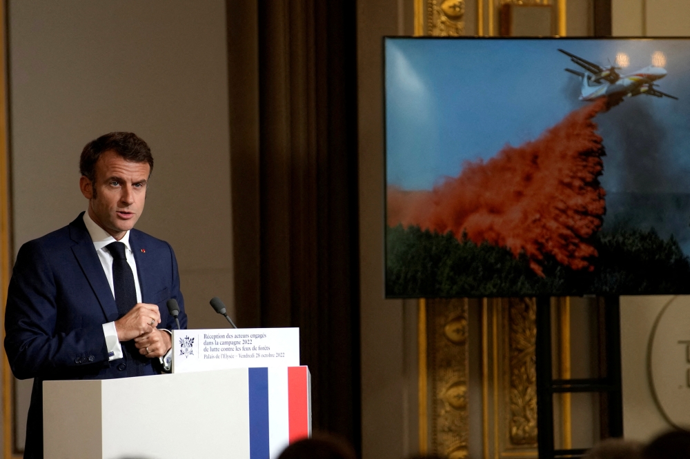 French President Emmanuel Macron delivers a speech in front of people involved in fighting wildfires last summer, at the Elysee Palace in Paris, France, October 28, 2022. Christophe Ena/Pool via REUTERS
