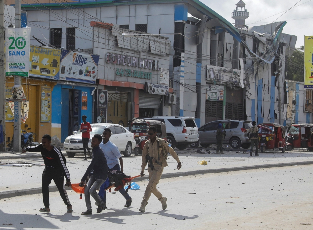 An injured civilian is evacuated from the scene of an explosion near the education ministry building along K5 street in Mogadishu, Somalia, on October 29, 2022. REUTERS/Feisal Omar