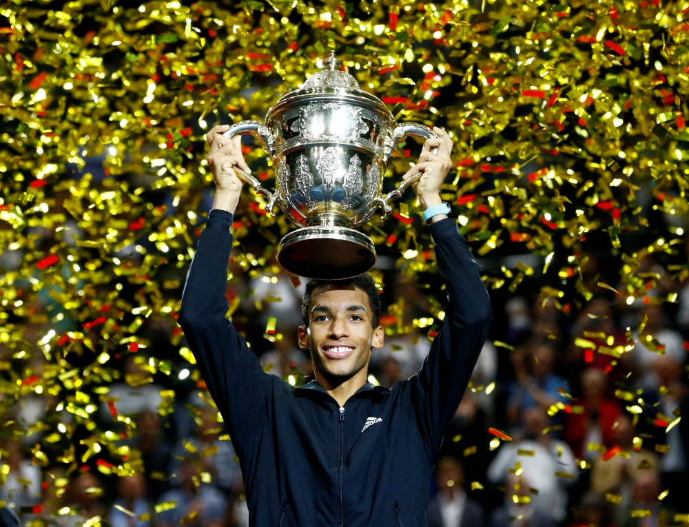 Canada's Felix Auger-Aliassime celebrates with the trophy after winning his Swiss Indoors Basel final match against Denmark's Holger Rune at St. Jakobshalle, Basel, Switzerland, on October 30, 2022.  REUTERS/Arnd Wiegmann 