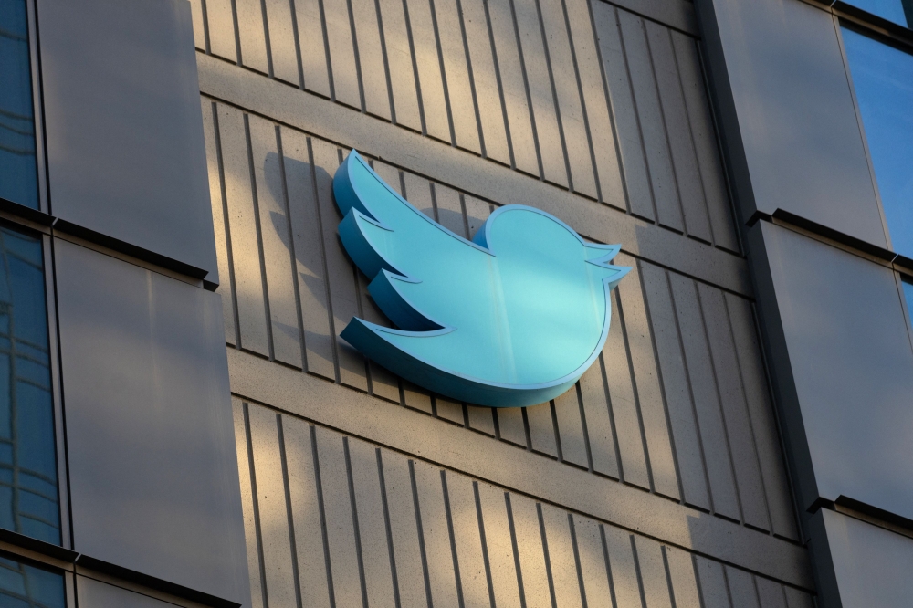 In this file photo taken on October 28, 2022, the Twitter logo is seen on the exterior of Twitter headquarters in San Francisco, California.  (Photo by Constanza HEVIA / AFP)