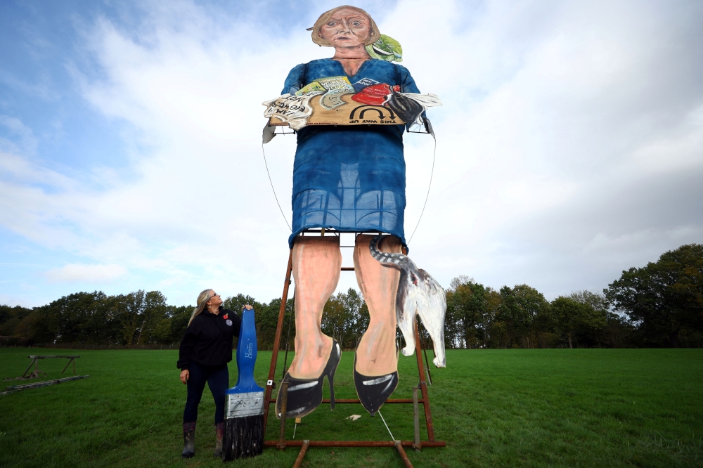 Artist Andrea Deans poses with the 11-metre effigy of former British Prime Minister Liz Truss unveiled today ahead of the Edenbridge Bonfire Celebrations in Edenbridge, Britain, November 2, 2022. Reuters/Hannah McKay