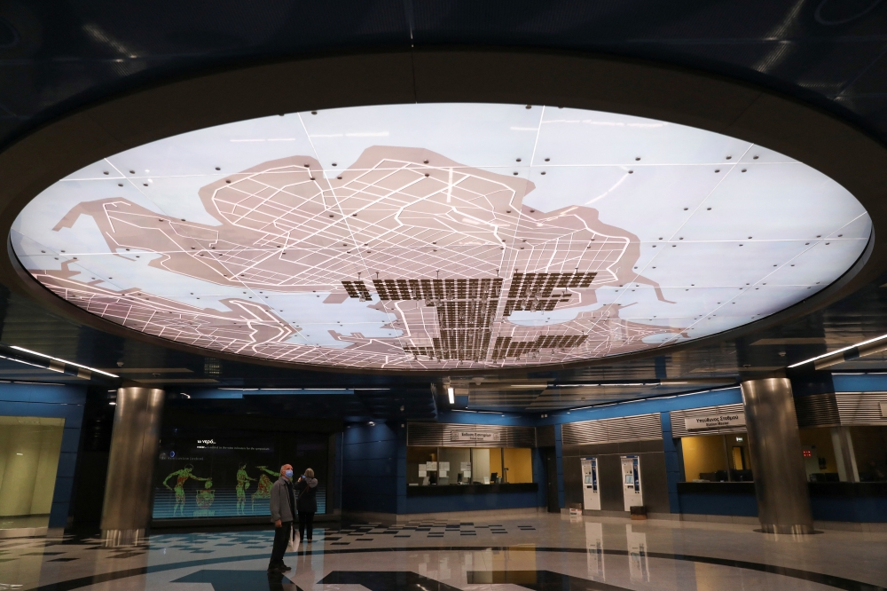 A person looks at a map of Piraeus that showcases the ancient irrigation system inside Piraeus subway station, near Athens, Greece, October 19, 2022. REUTERS/Louiza Vradi