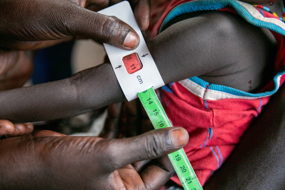 Regina Williams is screened for malnutrition at the Nyong Primary Health Care Unit (PHCU) nutrition site in Torit in this photo released November 3, 2022. World Food Programme/Handout via Reuters