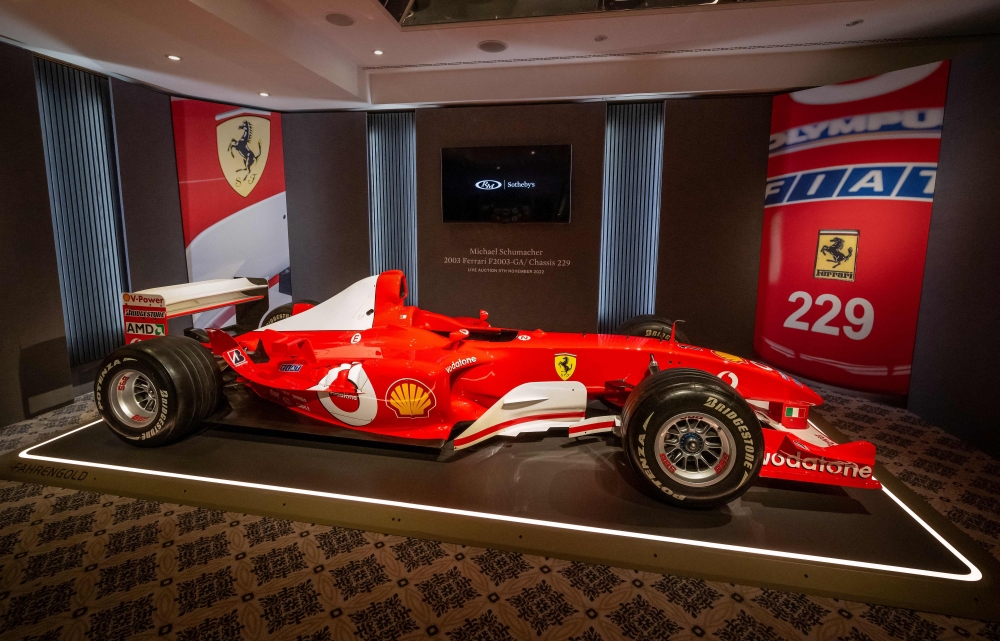 This photograph taken on November 4, 2022, shows F1 World Champion Michael Schumacher's Formula One Ferrari F2003 GA with chassis number 229 during Sotheby's auction house preview in Geneva. (AFP/Fabrice Coffrini)
