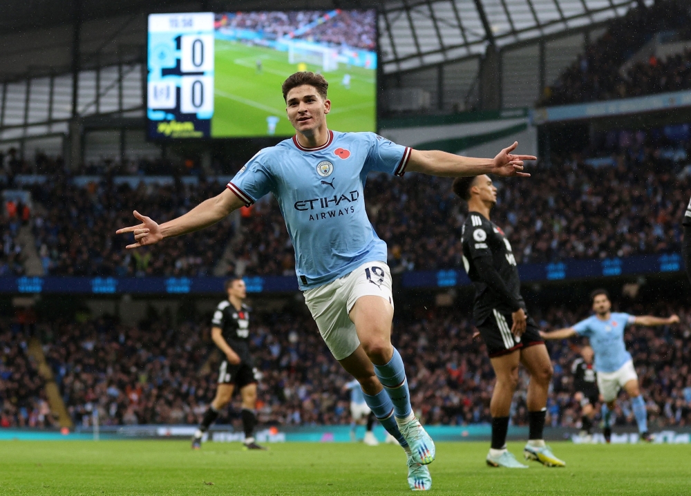 Manchester City's Argentinian striker Julian Alvarez celebrates scoring the opening goal during the English Premier League football match between Manchester City and Fulham at the Etihad Stadium in Manchester, north west England, on November 5, 2022. (Photo by ADRIAN DENNIS / AFP)