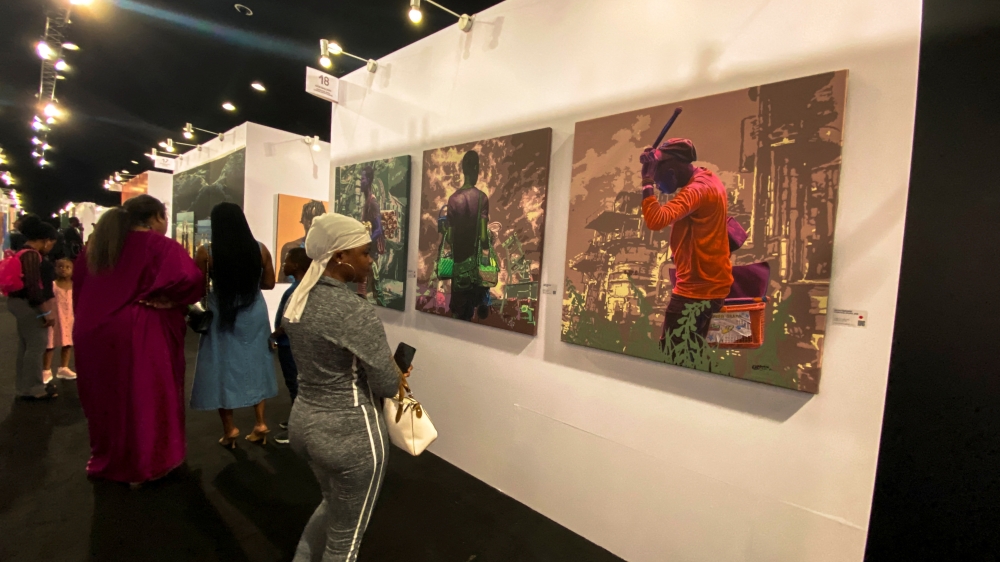 A woman looks at a painting at the Art X, an annual art fair held in Lagos, Nigeria November 5, 2022. REUTERS/Seun Sanni