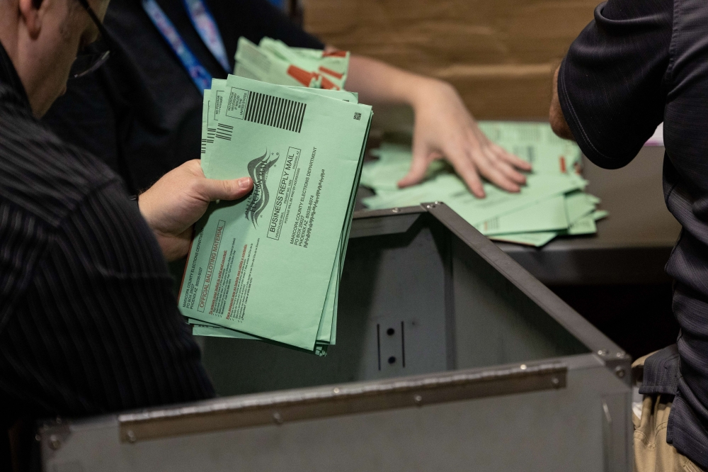 Election workers sort envelopes of ballots at the Maricopa County Tabulation and Election Center on November 08, 2022 in Phoenix, Arizona. John Moore/AFP
