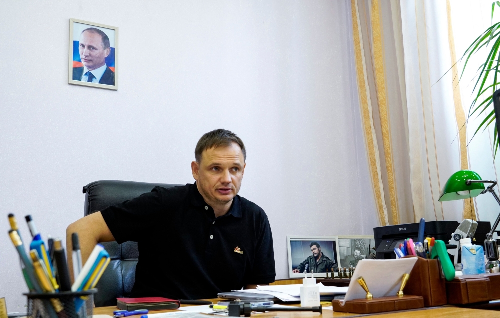 In this file photo taken on July 20, 2022 Kirill Stremousov, deputy head of the Russian-backed Kherson administration, is pictured in his office, with a portrait of Russian President Vladimir Putin seen on the wall behind him, in the city of Kherson, amid the ongoing Russian military action in Ukraine.  (Photo by STRINGER / AFP)