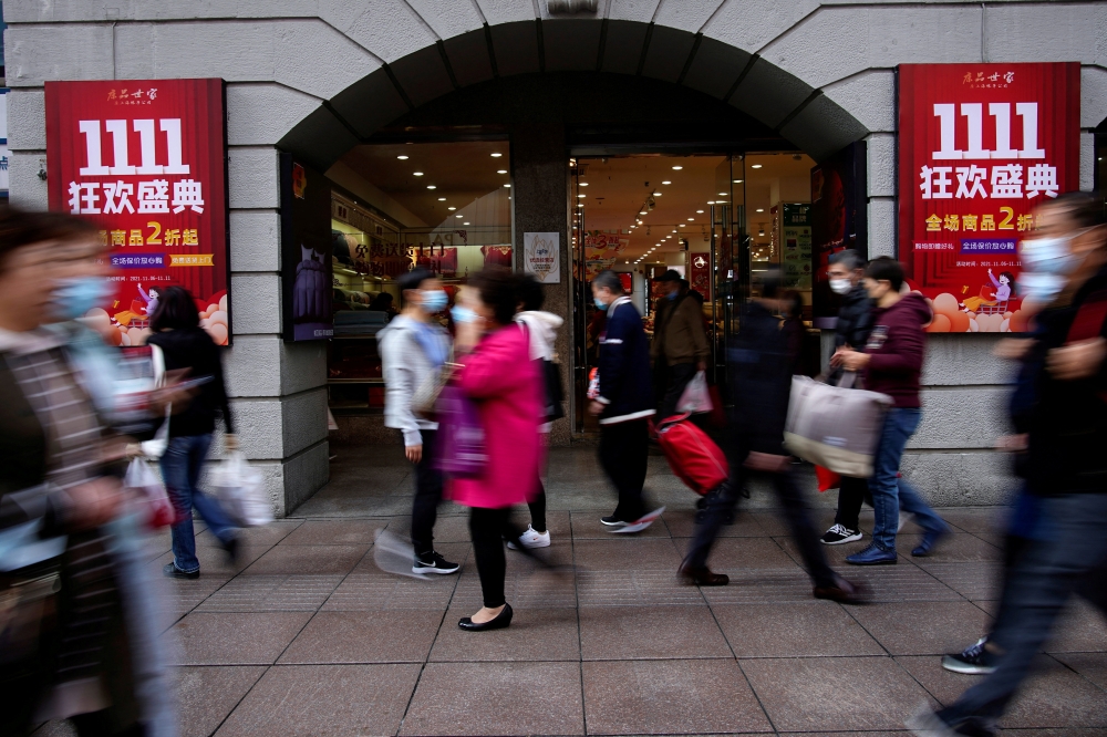 People walk along a main shopping area during the Alibaba's Singles' Day shopping festival in Shanghai, China November 11, 2021. REUTERS/Aly Song/File Photo
