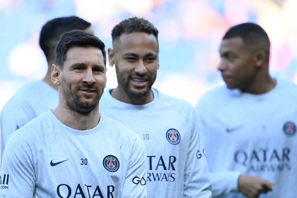 Paris Saint-Germain's Argentine forward Lionel Messi, Brazilian forward Neymar, and French forward Kylian Mbappe warm up prior to the French L1 football match between Paris Saint-Germain FC and AJ Auxerre at the Parc des Princes stadium in Paris on November 13, 2022. (AFP/Franck Fife)