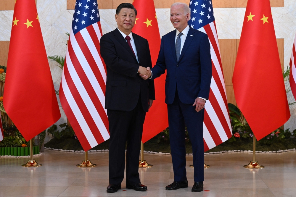 US President Joe Biden (R) and China's President Xi Jinping (L) meet on the sidelines of the G20 Summit in Nusa Dua on the Indonesian resort island of Bali on November 14, 2022. Photo by Saul Loeb / AFP