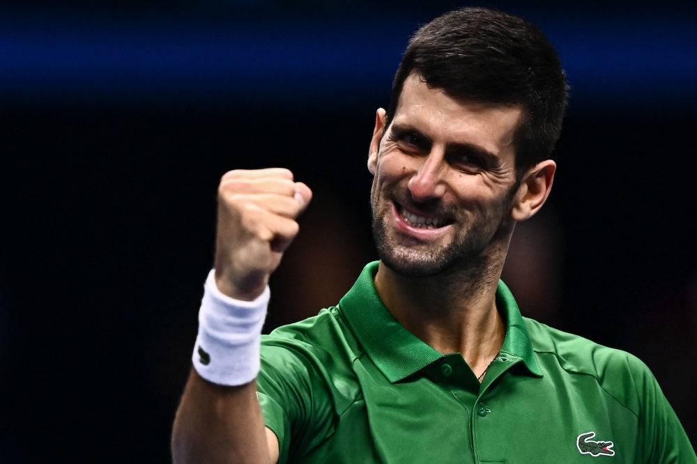 Serbia's Novak Djokovic celebrates after winning his first round-robin match against Greece's Stefanos Tsitsipas at the ATP Finals tennis tournament on November 14, 2022 in Turin. (Photo by Marco BERTORELLO / AFP)