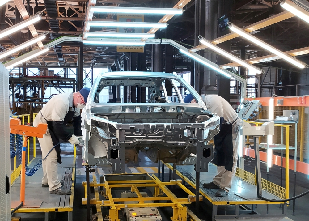 Employees work at the assembly line of the LADA Izhevsk automobile plant, part of the Avtovaz Group, in Izhevsk, Russia, on February 22, 2022.  File Photo / Reuters
