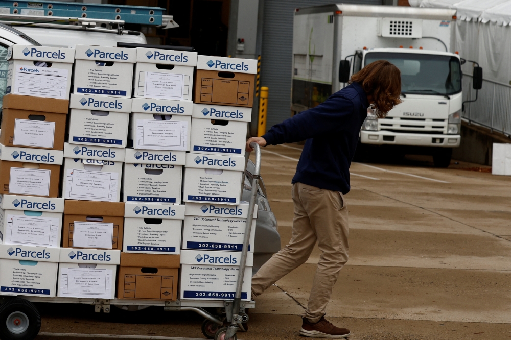 A person transports boxes with documents for the trial of Elon Musk, Chief Executive Officer (CEO) of SpaceX, Tesla and Twitter, regarding his Tesla pay package at the Delaware Court of Chancery in Wilmington, Delaware, U.S., November 16, 2022. REUTERS/Evelyn Hockstein