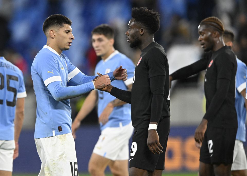 Canada's Alphonso Davies shakes hands with Uruguay's Mathias Oliveira (left) after their international friendly match at Tehelne pole, Bratislava, Slovakia, on September 27, 2022.  File Photo / Reuters

