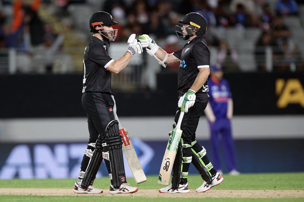 New Zealand's captain Kane Williamson (L) and Tom Latham celebrate during the first one-day international cricket match between New Zealand and India at Eden Park in Auckland on November 25, 2022. Photo by David Rowland / AFP