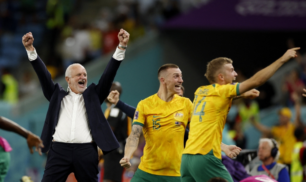 Australia coach Graham Arnold celebrates with Australia's Riley McGree and after qualifying for the knockout stages of the FIFA World Cup Qatar 2022 after defeating Denmark at the Al Janoub Stadium in Al Wakrah on November 30, 2022.  REUTERS/John Sibley