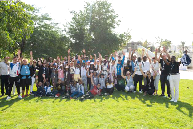 TotalEnergies Qatar officials with youth pose for a photograph.