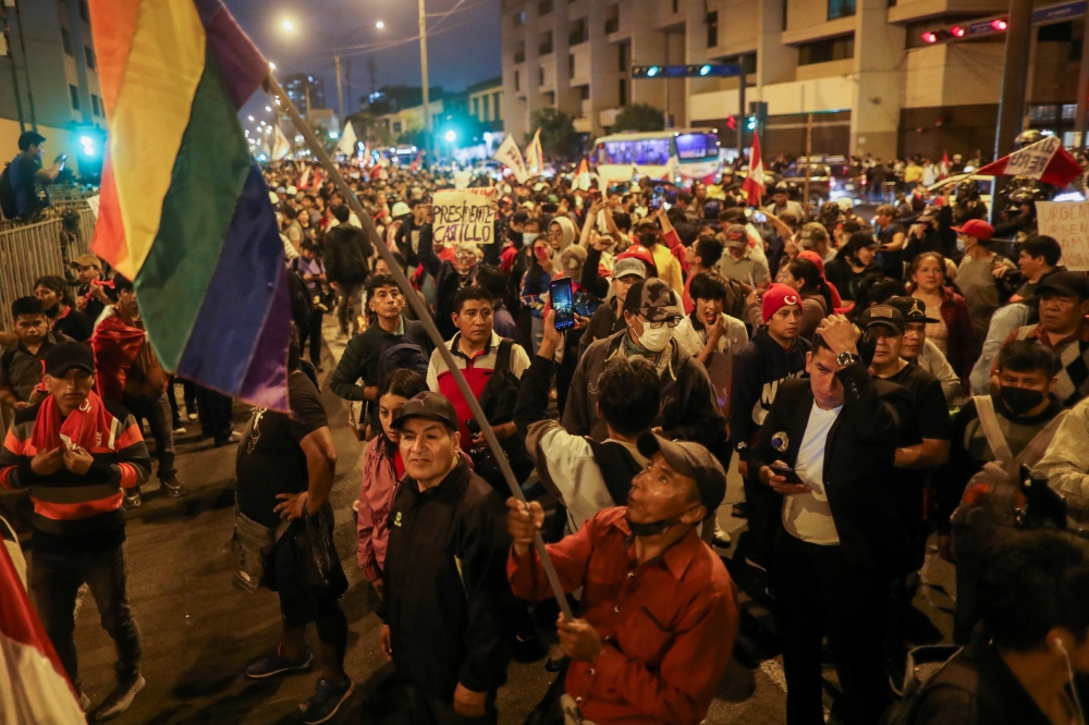 People take part in a protest demanding the closure of Congress after Peruvian leader Pedro Castillo was ousted and detained in a police prison, in Lima, Peru, on December 10, 2022. REUTERS/Sebastian Castaneda