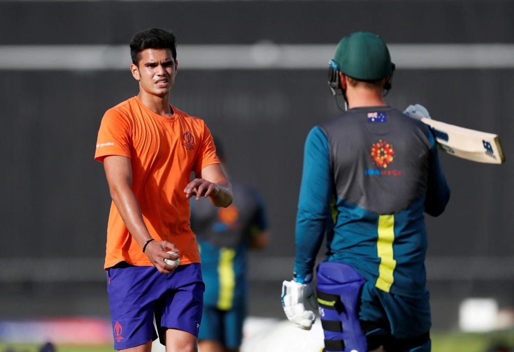 File photo: Arjun Tendulkar, son of Sachin Tendulkar, speaks with Australia's Aaron Finch during training Action Images via Reuters/Paul Childs/File Photo