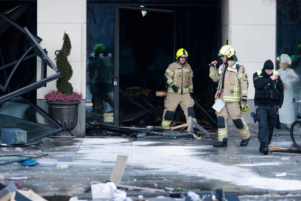 Emergency services work on a street outside a hotel after a burst and leak of the AquaDom aquarium in central Berlin near Alexanderplatz, with water poured out onto the street, in Berlin, Germany, December 16, 2022. REUTERS/Michele Tantussi TPX IMAGES OF THE DAY