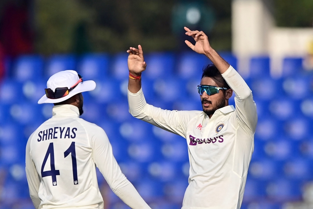 India's Axar Patel (R) celebrates with teammates after the dismissal of the Bangladesh's Mushfiqur Rahim (not pictured) on December 17, 2022. (Photo by Munir uz Zaman / AFP)