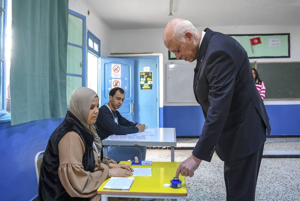 A handout picture provided by the press service of Tunisian presidency shows President Kais Saied casting his ballot at a polling station in the Ennasr district near Tunis on December 17, 2022, during the parliamentary election. (Photo by Tunisian Presidency / AFP)
